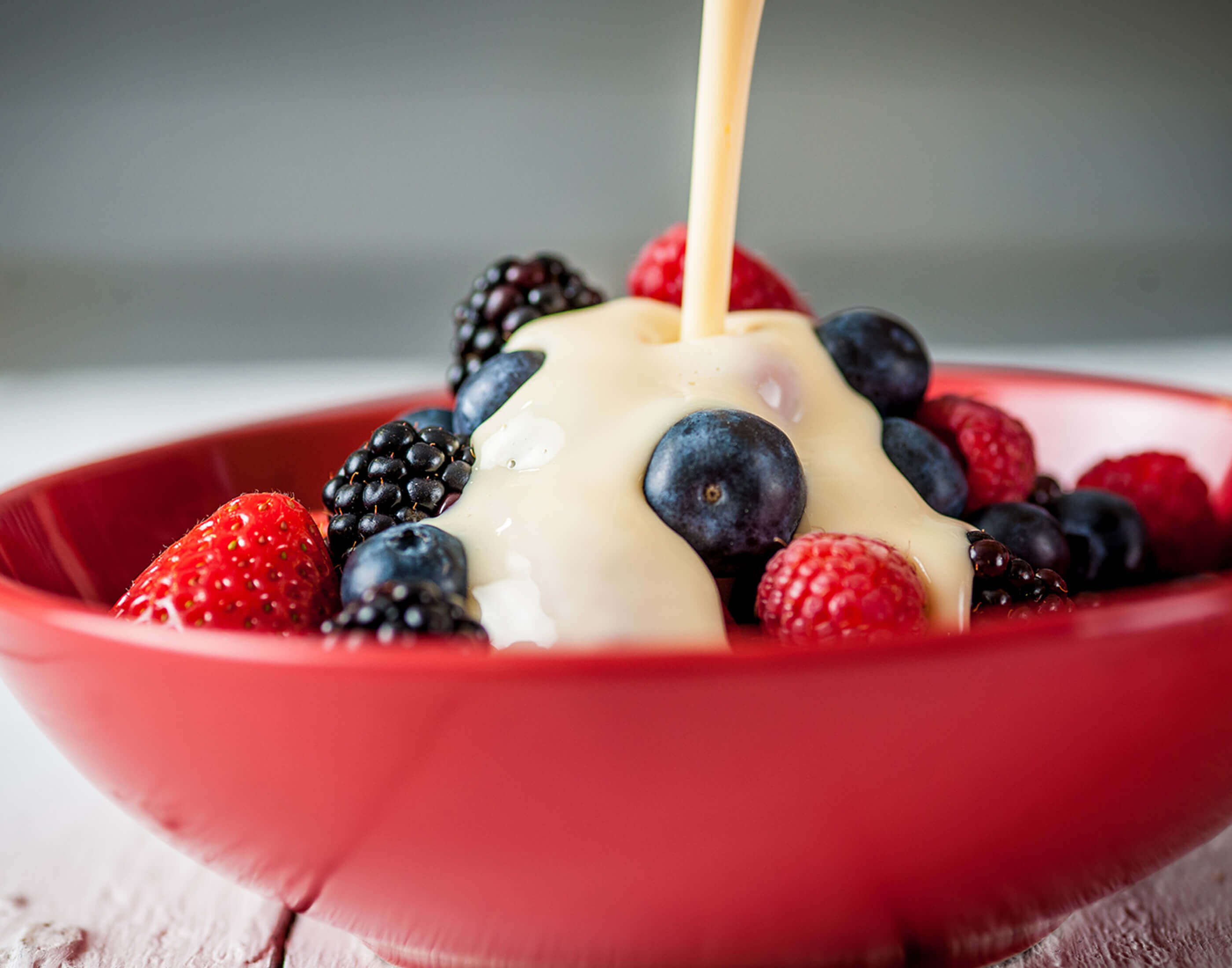 Carnation Evaporated milk poured over fruit