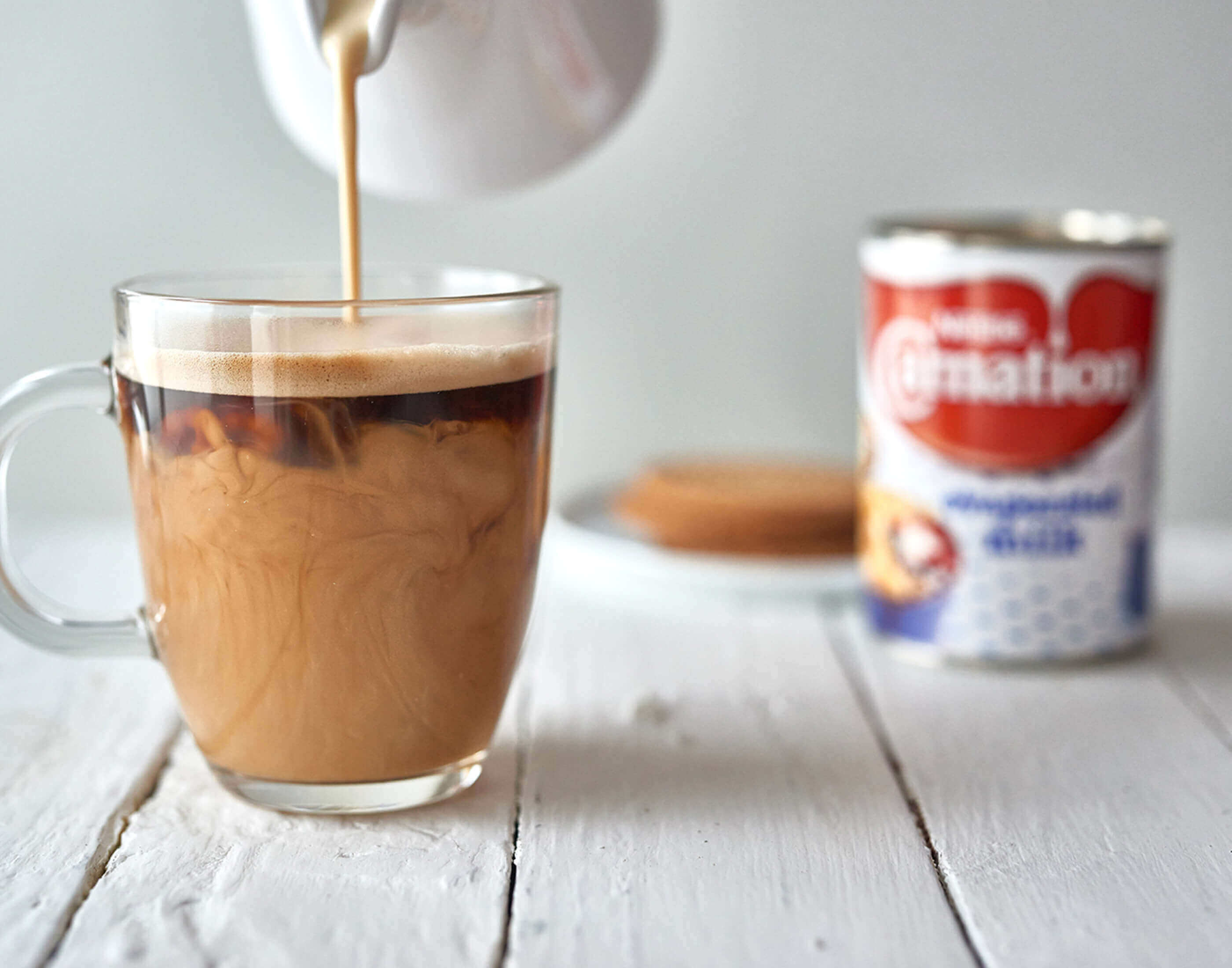 Light evaporated milk poured in tea/coffee