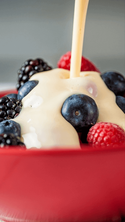 Carnation Evaporated milk poured over fruit