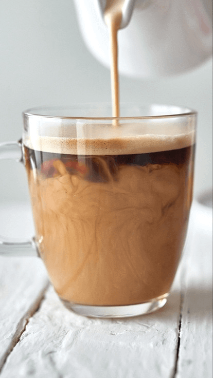 Evaporated milk poured in tea/coffee
