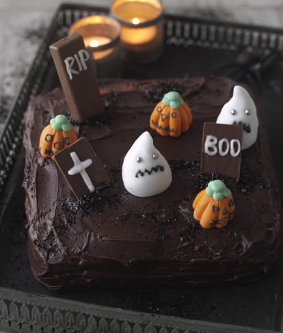 Graveyard Cake with pumpkins and ghosts made from icing