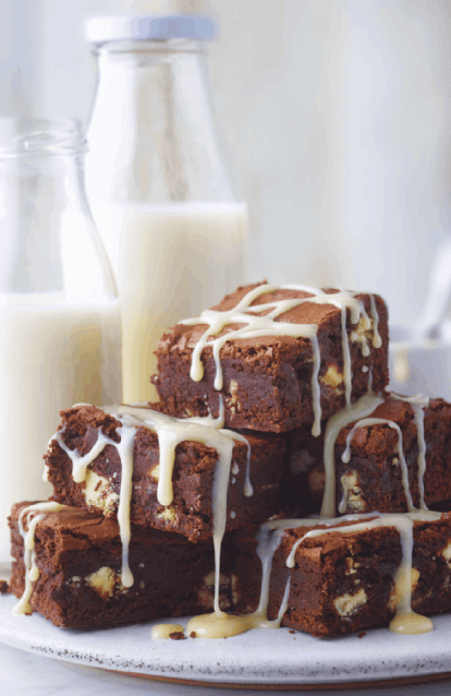chocolate brownies with carnation original drizzle on top with milk bottles