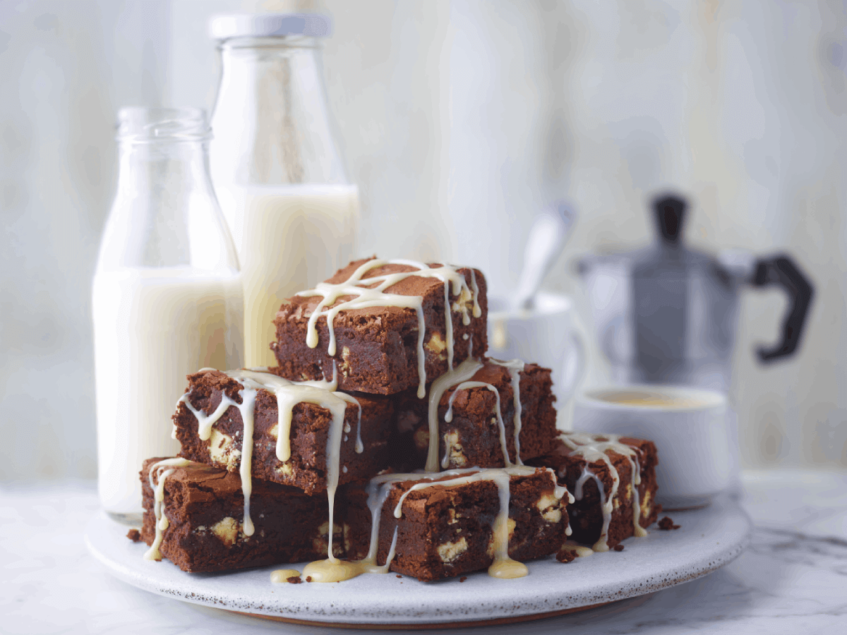 chocolate brownies with carnation original drizzle on top with milk bottles