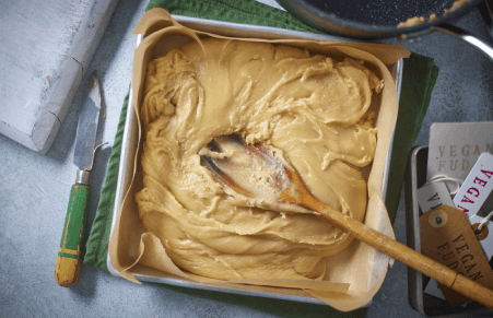 Vegan Fudge being pressed into a tin