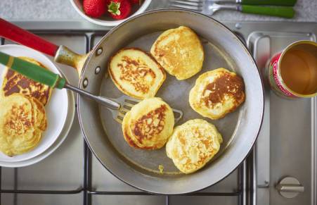 vegan pancakes cooking in frying pan