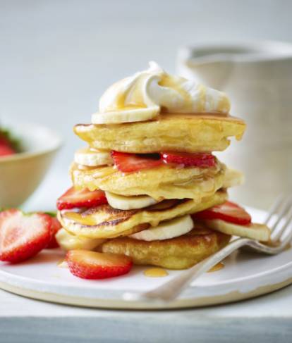 vegan pancake stack layered with strawberries and bananas