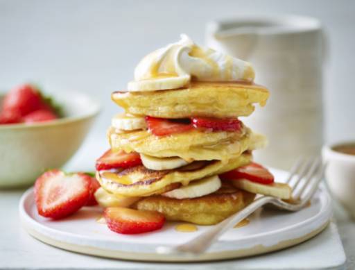 vegan pancake stack layered with strawberries and bananas