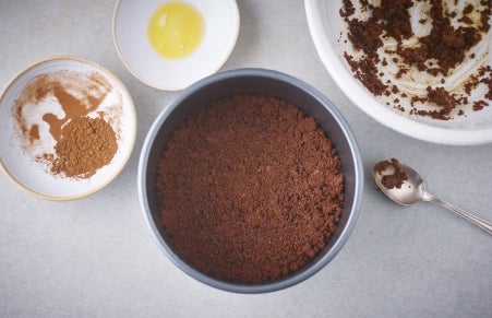 crushed biscuits in tin for the base of the cheesecake