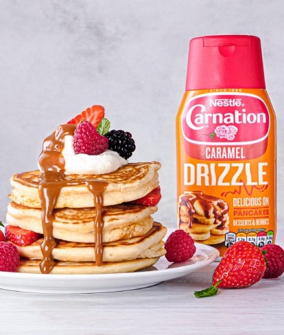 carnation caramel drizzle sauce with pancakes topped with fruit and caramel sauce