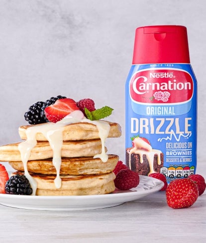 carnation original drizzle sauce with pancakes topped with fruit and sweetened condensed milk sauce