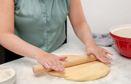 Doughnut dough being rolled