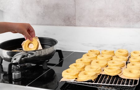 Doughnuts being placed into the oil