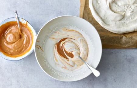 Pavlova caramel and cream being whisked