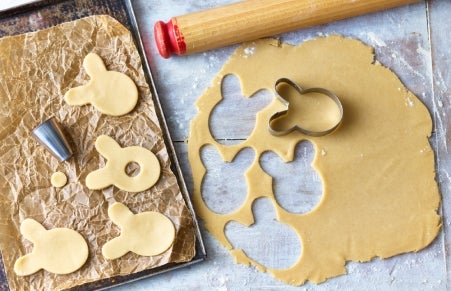 rolled biscuit dough being cut into bunny shapes