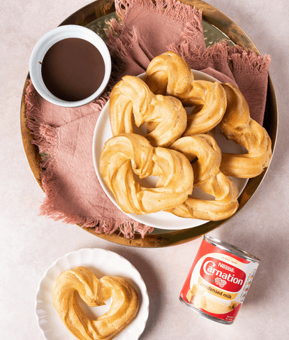 Heart shaped churros with chocolate sauce for Valentines Day