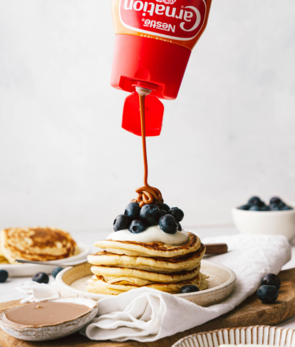 carnation caramel drizzle sauce with pancakes topped with fruit and caramel sauce