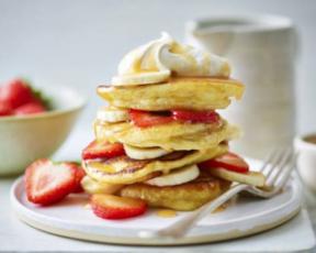 vegan pancake stack layered with strawberries and bananas