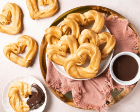 Heart shaped churros with chocolate sauce for Valentines Day