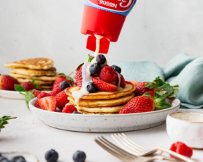 carnation original drizzle sauce with pancakes topped with fruit and sweetened condensed milk sauce